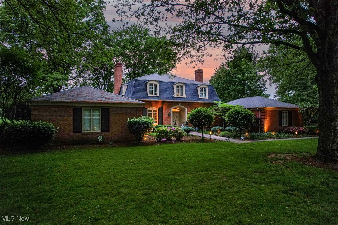 Experience refined living in this STUNNING 4-bedroom, 4.5-bath home with over 5,000 sq. ft. in sought-after Country Club Estates & Howland Schools. Enjoy BREATHTAKING golf course and pond views from nearly every room. The grand foyer with custom Finelli railing opens to a spacious living room with hardwood floors and gas fireplace. The SPECTACULAR gourmet kitchen features custom cabinetry, designer backsplash, leaded glass, center island, and ample pantry space—perfectly complemented by a formal dining room with sweeping views. The first-floor primary suite offers a spa-like bath with a floor-to-ceiling tile shower and an expansive dressing area with eight double closets. Also on the main level: a library with fireplace, two half baths, and a morning room. Upstairs, find a guest suite with private bath, two large bedrooms, a third full bath, and a home office area. The finished lower level adds a stylish rec room with metallic epoxy floors. Step outside to a show-stopping brick patio with hot tub, built-in grill, gas firepit, and stunning outdoor vistas. Recent updates: dual furnaces & A/C units (2019), 75-gallon water heater, updated electrical, and backup sump pump. Meticulously maintained and move-in ready—luxury living at its finest.
