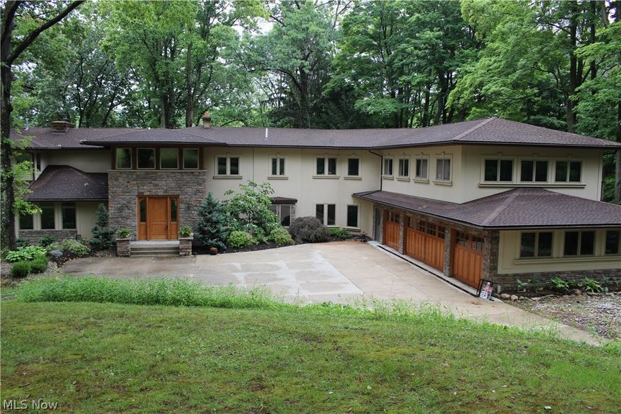Stunning 2-story, 4 bed, 3.5 bath home nestled on almost 9 private acres in Bath Township. With nearly 6000 sq. ft., this home has been beautifully renovated with high end finishes throughout, including 2000 sq ft addition in 2004. Welcoming 2-story foyer with impressive architectural details and marble flooring. Chef's kitchen with custom cabinetry, granite countertops,  2  islands and high end stainless steel appliances.  Adjoining Great Room with soaring ceiling, gas fireplace, wood floors and additional space for dining open to expansive deck.  Three season sun room to enjoy the beautiful views.  First floor office, living room w/ fireplace and formal dining off kitchen w/cherry wood floors. Convenient first floor laundry and mudroom.  Front and rear staircases to the second floor plus private staircase leads to master suite with walk in closet, dressing area, fireplace and private deck. Spa-like master bath with glass enclosed shower, soaker tub, h/h vessel sinks, travertine finis