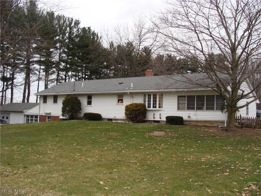 Home is presently a ranch style duplex-could easily be single family home.  Bay windows, 3 full baths, 2 enclosed porches, and sun room, family room, 3 garages plus barn. Central air and window air.  Some wood flooring, some newer windows & most appliances stay.  Paved driveway, patio, deck beside Coy Park.     Currently being used as a multi-family but can easily be converted to a beautiful single family residence.
