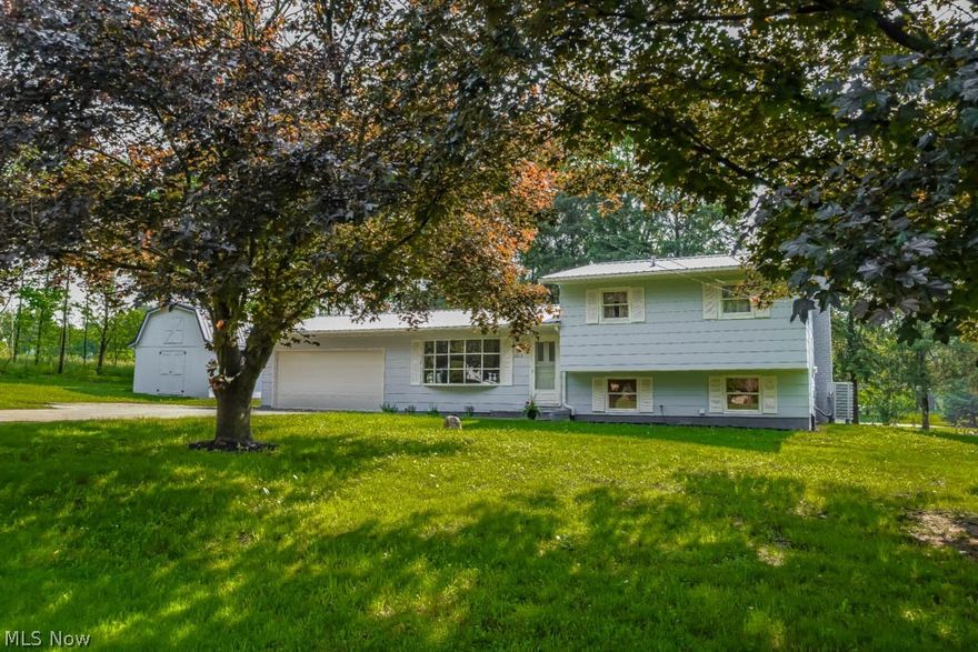 Charming, updated 3 bedroom in a nice country setting on half an acre! Welcoming foyer with tile flooring opens to a spacious living room boasting gleaming hardwoods and a huge bay window. Charming built-ins frame the entryway to the eat-in kitchen, which is fully applianced with NEW stainless steel appliances, NEW countertops, sink and faucet. Lots of natural light through a large window in the dinette. Modern fixtures and touches throughout! Upstairs, there are 3 bedrooms with hardwood floors and ceiling fans as well as a full bath with tile flooring and deep linen storage. The lower level offers a walkout family room with a fireplace, wood mantle and a live edge bar set against reclaimed barnwood. Sliding doors open to the covered back patio. Utility side of the lower level is freshly painted and includes laundry hookup. 2-car attached garage with extra driveway parking. New on demand hot water heater, new lifetime metal roof, new efficient furnace/AC, new appliances and reclaimed barnwood on the lower level! Outside, enjoy your serene backyard from your covered patio. Bonus 20x16 storage shed with an adorable interior and steps up to a loft. Move-in ready home - don’t miss out!