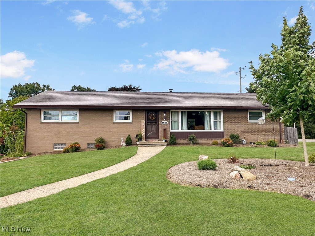 Cozy all brick raised-ranch in prime Jackson Twp. location. Home sits on a corner lot and features four bedrooms and 2 full baths. You'll enjoy the privacy that this split floor plan provides with the primary bed and bath separated from the other 3 bedrooms on the main level. The living room has a large picture window for plenty of natural light. The galley kitchen includes all appliances and has a lovely window with shelving over the sink. The dining room has sliding doors leading out to a 3-season sunroom with glass on all sides for plenty of sunshine! The sunroom overlooks your fully fenced backyard with a garden. The large walkout basement has plenty of room for storage, or could be finished as additional living space! Storage shed will stay. Furnace 2016.Newer vinyl windows and metal roof. Schedule your showing today!