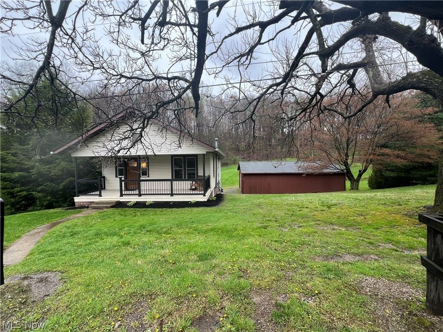 Situated at the edge of town is this recently renovated 2 bedroom 1 bath ranch home with many updates throughout.   The home comes with an updated kitchen and the kitchen appliances can stay, there's ceramic tile flooring, new kitchen cabinets, countertops and backsplash and a formal dining room with built ins for more storage.  The hardwood floors are in good shape in the living room as well as the dining room, There's a covered front porch to sit and relax on that has new railing and flooring, a back deck for privacy and a full walkout basement with a 2 car garage area. There's a 4 car detached garage with concrete floor and new LED lights, A new furnace and central air, new electric coming into the house and garage with both new boxes.  new garage door and opener,  the BDRY system installed in basement front wall and sump pump added in 2023 and brand new septic areation system installed in 2020.  Mini blinds stay with the house.   Mineral and gas rights do not stay with the property.