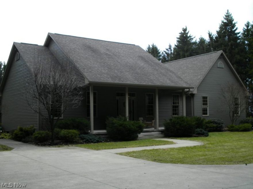 Custom built hand crafted ranch home on 4 acres of privacy surrounded by trees. The foyer leads to a  living room with 19 ft cathedral ceiling. Natural light throughout, stone fireplace with gas logs. Formal dining area has view of private front yard. Open floor plan includes kitchen with breakfast area overlooking deck and pool.  Master bedroom suite with 16 ft cathedral ceiling, poplar wood floor, private bath featuring whirlpool tub, double sinks, walk in closet. 2 additional bedrooms, full bath, laundry area and half bath complete the living area of this home.  Maple barn wood floors in living room and dining room. Ceramic tile in kitchen and baths. Solid poplar doors. 2 car attached garage. Home includes custom window treatments and light fixtures, all appliances, all pool equipment, all outside patio furniture.  Private tree lined driveway.  Mineral rights do not transfer.