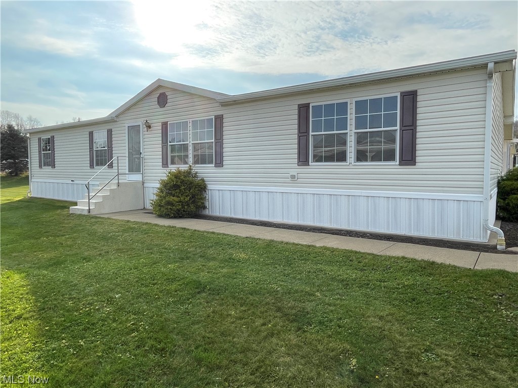 Clean and ready to move into, Nantucket Modular home with large carport, and concrete driveway. Spacious open concept. First-floor laundry. Located in the Woodale Village retirement community just west of Minerva off SR 30. Quiet and clean area and good management. The lot rent is $265 per month. City water and sewer.
