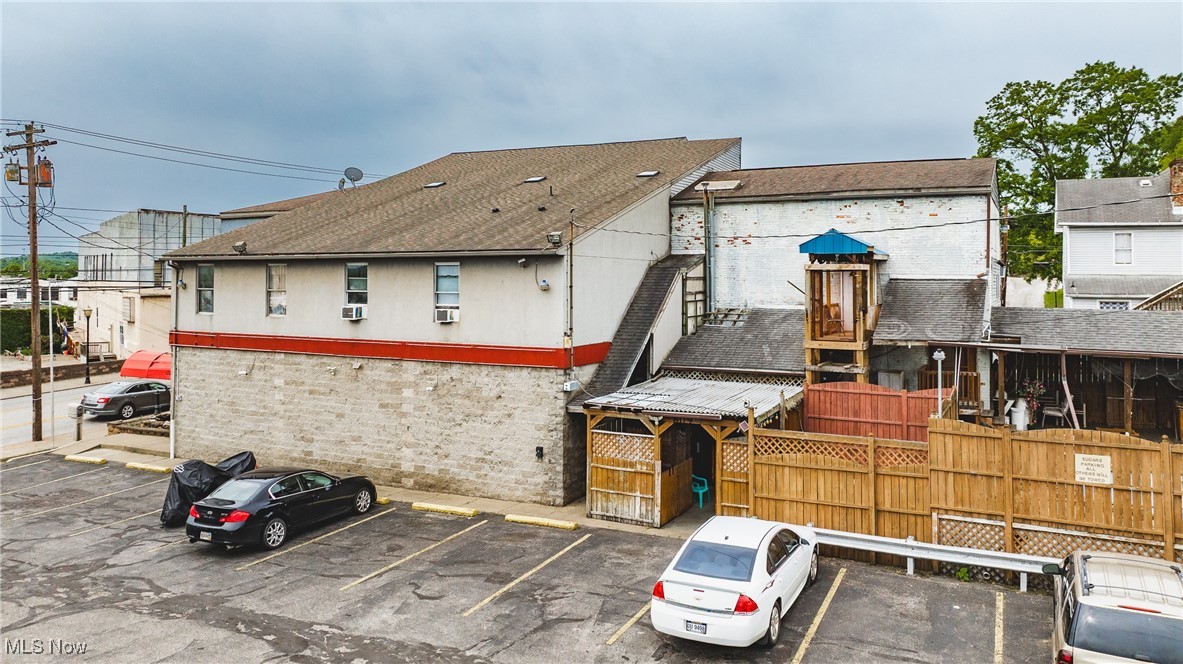 High-Traffic Investment Opportunity in Parkersburg, WV – Six (6) Parcels
Located on high-visibility Seventh Street in Parkersburg, West Virginia, this rare commercial property spans seven parcels in one of the city’s most trafficked areas. Formerly operating as a nightclub, the main structure includes a commercial kitchen, two full bars, public restrooms, and a dressing area—ideal for continued entertainment use or future redevelopment.
The property also includes a variety of income-generating residential units, all with owner-paid utilities, as well as ample parking and an oversized three-car garage with garage apartments. Residential breakdown includes:
Attached Owners Apartment: Elevator access, two bedrooms, one full bath, open-concept kitchen/living area, plus two sleeping
rooms with a shared bathroom (each sleeping room rents for $500/month). Two Garage Apartments (above oversized 3-car garage): One 2-bedroom and one 1-bedroom unit, each renting for $600/month. Two Additional Units: Located near the private courtyard, renting for $700/month and $600/month respectively. Estimated Gross Monthly Rental Income: $4,500 (Based on full occupancy and current rental rates) With multiple income streams, strong commercial potential, and a prime location, this versatile property is an outstanding investment opportunity in the heart of Parkersburg.