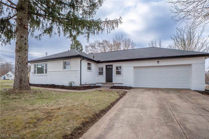 Welcome to 398 Snyder Avenue, a beautifully updated ranch offering stylish finishes, easy one-floor living, and a convenient Barberton location. This 3-bedroom, 1-bath home has been thoughtfully renovated from top to bottom, making it move-in ready for its next owner. A cute breezeway connects the attached 2-car garage to the main house and provides a practical space for coats, shoes, and everyday entry. Inside, the bright living room is filled with natural light from large windows and opens into the updated eat-in kitchen featuring new cabinetry, countertops, stainless steel appliances, and pantry storage. Two bedrooms are located on the main level, including a generously sized primary bedroom with double closets, along with a full bathroom complete with new vanity, mirror, lighting, commode, and flooring. The lower level adds flexible living space with a finished rec room, third bedroom, and additional room for storage or hobbies. Outside, enjoy the new front stoop, deck, and spacious yard with room to relax, play, or entertain. Major updates include new vinyl siding, soffits, gutters, roof, windows, exterior doors, flooring, furnace, central air, hot water tank, garage door opener, and 100-amp breaker box. This is a great opportunity to own an updated home with modern improvements already done for you.