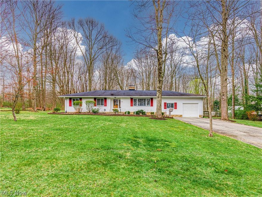 Welcome to this beautifully updated 1,446 sq ft ranch on .71 acre—where comfort, style, and nature come together. You’ll appreciate the well-manicured lawn, colorful flower beds, and wooded views from both the front and back of the home. 
Step inside to a welcoming entryway featuring built-in cabinetry, and convenient coat closet. The spacious living room offers a wood-burning brick fireplace, raised hearth, additional shelving, and a large picture window that fills the space with natural light.
The adjoining dining area flows seamlessly into a stunning, updated white kitchen complete with abundant cabinetry, quartz countertops, and a full appliance package including electric stove, built-in microwave, dishwasher, refrigerator, washer, and dryer. The enclosed back porch, with four large windows and ceiling fans, overlooks the lush backyard. Step outside to the patio—to relaxing or entertain.
Off the dining area, you’ll find a convenient half bath, 5x5 walk-in pantry, and a versatile flex room that can serve as a home office or fourth bedroom. The attached garage includes an opener, utility area, shelving, a man door, and plentiful parking.
On the opposite side of the home are three comfortable bedrooms. One is currently set up as a craft room/home office with built in desk, shelving. The remaining two bedrooms feature carpeting, closets, and large windows that bring in natural light and views of the surrounding yard. The updated full bath includes a tub/shower combo and a spacious vanity for all your essentials.
Throughout the home, you’ll find luxury vinyl plank flooring, custom blinds, storage and closet space, and neutral décor.. Outdoor enthusiasts will love the convenient location near West Branch State Park, Lake Milton State Park, and Berlin Reservoir—perfect for fishing, boating, and swimming. Plus, enjoy easy access to nearby expressways, making commuting simple while still enjoying peaceful country living. Don't miss this opportunity to make it yours!