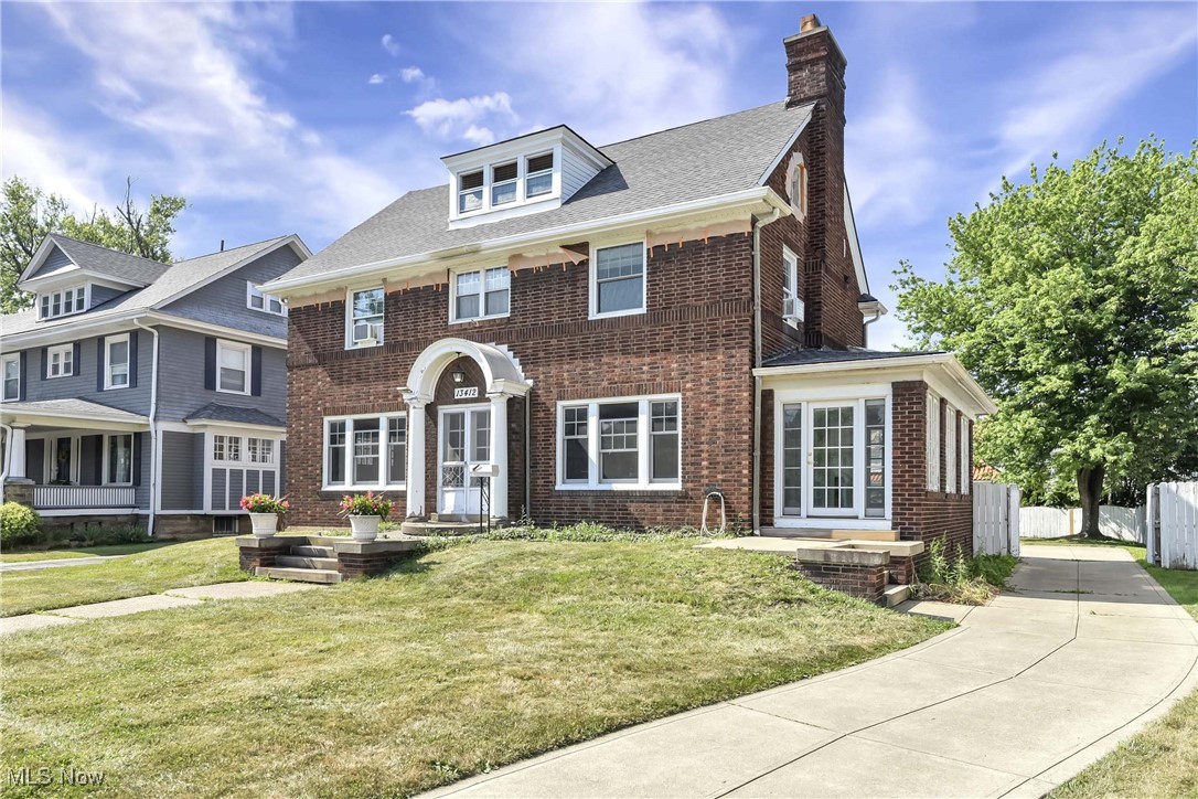 Welcome to 13412 Clifton Blvd - a charming 4 bedroom, 2.5 bath brick center hall colonial located in a highly desirable and walkable Lakewood neighborhood. This home blends the craftsmanship of a bygone era with thoughtful renovations required for modern day living. A total renovation of the kitchen and first floor half bath was completed in 2023. The large, island is a gathering spot, and includes a wine/beverage frig and many thoughtful drawers w/pull out cabinetry. Z-line appliances, double wall ovens, quartz countertops, extra deep sink, a potfiller faucet, and separate coffee bar area are some of the highlights. Plus the added warmth and comfort of heated tile floors. The first floor is light and bright, with large rooms, gorgeous original hardwood floors, black walnut and mahogany woodwork moldings and trim. Inviting foyer with carved doors conceal an ample guest closet. A two sided fireplace (gas) is an architectural feature in the living room and all season sunroom. Loads of french doors. Many, newer, Marvin replacement windows (2019) throughout the home. Heading up the beautifully turned staircase brings you to 4 good sized bedrooms. One is being used as an office and has a private porch (no photo). The master bedroom has a decorative fireplace and walk in closet. The pristine full bath with spacious shower, also renovated in 2023, includes heated floors. Another staircase leads to the third floor which has original hardwood floors, a full bath with a claw foot tub and a fireplace. Use of this space is limitless! The unfinished basement includes a laundry area. The washer and dryer will remain. There is a functioning commode in the basement. The attached two-car garage is currently being used as a workshop. The present owners have maintained the mechanicals, replaced the roof (2016), and made many improvements along the way. They are the third owners having purchased in 2003. The fenced rear yard offers many untapped possibilities.