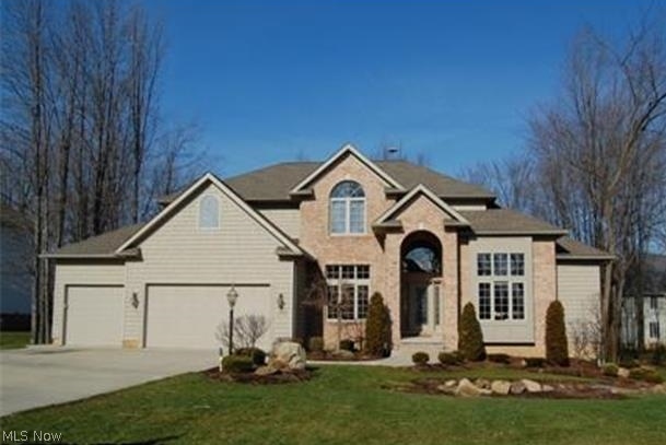 Located in the Revere School District. Absolutely gorgeous architecture and upgrades in this 9 year old, custom built home. Step into the foyer and your first view is the 20' Great Room with center fireplace and accenting windows. Library with 14' high, beamed ceiling. Huge Kitchen with upscale maple cabinetry, granite counter tops and hardwood floors. Cathedral Sunroom w/sliders to the deck and wooded lot. Spacious first floor Master Suite with glamour bath. Finished lower level includes bedroom 5 or office, full bath, Home Theatre, Family Room, Kitchenette/Bar and plenty of storage. The second floor has 3 spacious bedrooms, jack-n-jill bath between bedroom 2-3, bedroom 4 has private bath. This home is a must see...quality construction, open & airy floor plan and over 5,000 square ft. of finished living space.