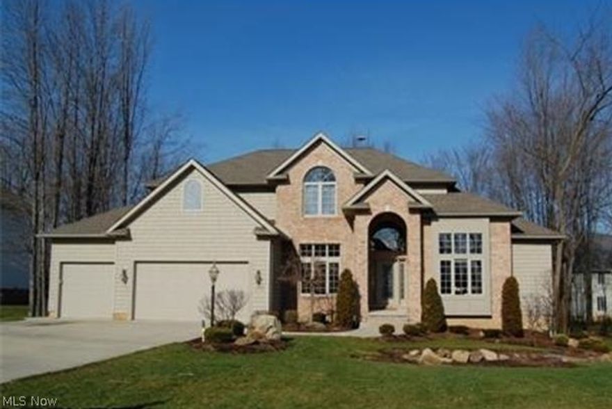 Located in the Revere School District. Absolutely gorgeous architecture and upgrades in this 9 year old, custom built home. Step into the foyer and your first view is the 20' Great Room with center fireplace and accenting windows. Library with 14' high, beamed ceiling. Huge Kitchen with upscale maple cabinetry, granite counter tops and hardwood floors. Cathedral Sunroom w/sliders to the deck and wooded lot. Spacious first floor Master Suite with glamour bath. Finished lower level includes bedroom 5 or office, full bath, Home Theatre, Family Room, Kitchenette/Bar and plenty of storage. The second floor has 3 spacious bedrooms, jack-n-jill bath between bedroom 2-3, bedroom 4 has private bath. This home is a must see...quality construction, open & airy floor plan and over 5,000 square ft. of finished living space.