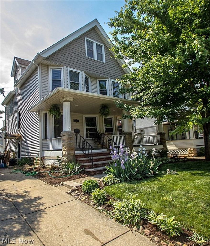 All the Lakewood charm you've been looking for with updated Kitchen and baths AND a first floor laundry!  Enter from the gracious, pillared front porch to large rooms with gorgeous woodwork, hardwood floors and newer windows.  Roomy Kitchen features granite, big island, bead board and lots of storage.  Dining room includes built in hutches, window seat and french doors to the back deck.  Living room has a gas fireplace and bay window.   Powder room and laundry round out the first floor.  Staircase has entry from both living room and kitchen.  Upstairs are 4 bedrooms, hardwood floors and exposed brick.  The two front bedrooms are good sized and have bay windows; either could be the master.  Fourth bedroom includes door to balcony overlooking backyard.  Bath is updated with ceramic tile floor and tub surround and pedestal sink.  Walk up attic is unfinished and provides storage.  Basement has been waterproofed.  This home also offers multiple options for outside entertaining.  Backyard is