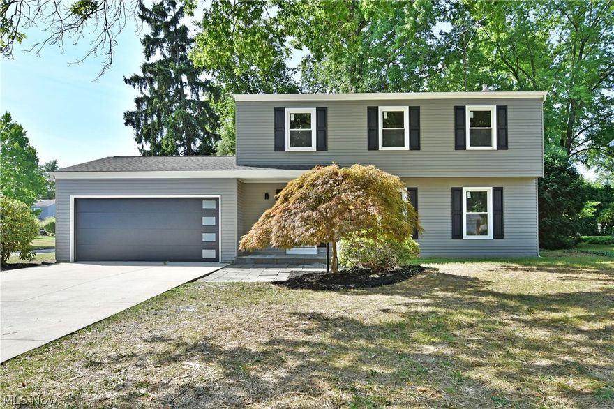 Two stories of beautifully updated. move-in-ready living space await this fantastic Warren residence; located in a desirable neighborhood! The sweeping corner lot showcases the handsome exterior with its sleek, dark garage door and matching shudders. A concrete drive leads up to the covered entry as tall trees rise above to include the park-like backyard. Step inside to find a welcoming family room as hardwood styled flooring runs below. A stylish half bath waits near the carpeted stairway while a stunning great room expands along the rear wall to combine the kitchen and dining areas. Natural light pours in from the multitude of windows, as a bay styled nook marks a great place for casual dining. Polished stone countertops glisten with the glass brick backsplash as custom white cabinetry accents the stainless appliances. Four spacious, carpeted bedrooms line the upper hall along with an inviting full bath with its tasteful vanity and shower. The master suite highlights its own full pri