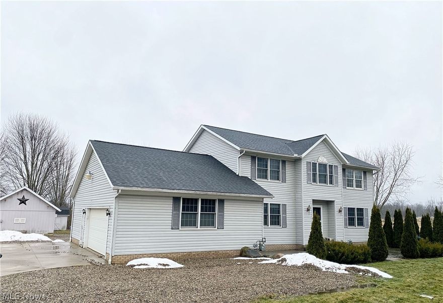 Space, privacy, and potential — this 2.83-acre Ravenna colonial offers 2,396 sq ft of living space with valuable recent upgrades already in place.

Built in 2005, this home features an open-concept layout and peaceful country surroundings with room to add your personal touch.

The main level includes a bright great room with a gas fireplace (10/2021) and a generously sized kitchen with abundant counter space, large center island, pantry, and newer range (3 years old). First-floor laundry with half bath adds everyday convenience.

Upstairs, the oversized owner’s suite offers a large bath with garden tub, walk-in closet, and expansive changing room. Additional bedrooms provide flexible living space.

Major improvements include a full tear-off roof (April 2023) with 30-year shingles and 50-year transferable warranty, septic pumped August 2025, whole-house water filtration system, and battery backup sump pump.

Outdoor highlights include a 16x16 deck, paver patio, stamped concrete front patio, dog kennel area, scenic backyard with stream, and multiple outbuildings including a 20x16 workshop for storage, hobbies, or workspace.

This property presents an excellent opportunity to enjoy acreage, privacy, and meaningful recent improvements