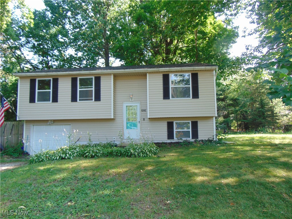 Madison Bi-Level in need personal touches and updating! Nice family home with 3 bedrooms, eat-in kit with sliders to deck, spacious living room, family/rec room on lower level.