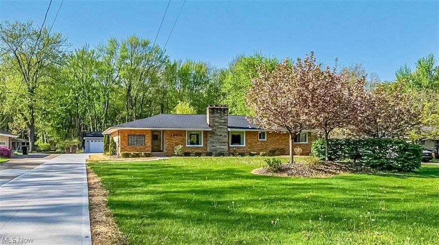 Rare 2.2-acre property with private wooded backdrop in Westlake, located in the highly rated Westlake City School District. This fully renovated ranch offers 3,169 sq ft of bright, open living space with one-floor convenience and a finished lower level. Ideally located near I-480, I-90, shopping, dining, and Crocker Park. Renovated in 2019, updates include electrical, plumbing, roof, HVAC, tankless hot water, smart thermostat, 200-amp service, garage subpanel, and EV charging station. The open main level connects the kitchen, dining, living, and great room with a stone fireplace and large picture windows overlooking the landscaped front yard. The kitchen features granite surfaces, a 10-foot island with 5-burner cooktop, built-in convection and speed ovens, wet bar, and dishwasher. Additional highlights include a powder room, first-floor laundry, and bright sunroom/mudroom. The primary suite offers a walk-in closet and private bath, with additional spacious bedrooms. The finished lower level includes a theater with 4K projector and screen, game room, office/flex space, and second wet bar. Unfinished space offers excellent storage, walk-in pantry, workshop, new windows, and completed waterproofing. Set back on a deep lot extending into scenic woods, the property offers rare privacy, open green space, and a mature weeping willow tree. South-facing rear exposure provides abundant natural light. Outdoor living includes a large deck, custom grilling station, outdoor TV, and patio dining area. A 3-car garage, 20x10 storage shed, and newly completed driveway complete this exceptional home. Upgraded warranty offered with property through APHW for 1 year.