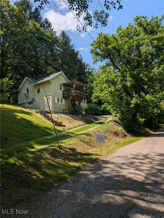 Cozy 2 bedroom, 1 bath home in country setting on .33 acre lot; recently remodeled; updated electric and plumbing and new carpeting throughout; Lots of extra living space in the lower level; one car garage; shared driveway. Come enjoy the views from the front deck of your new home. Offers the convenience of being close to town, but affording the privacy you desire. Extra parking area and space for additional garage or carport. Furniture shown can be negotiated with sale if desired. Being sold as is. Seller will pay up to $2,500 towards closing cost.