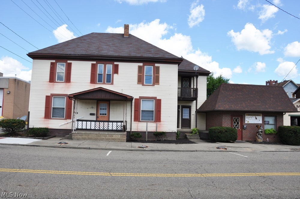 This is a large duplex with 1,232 sq ft on each floor. The first floor has been remodeled and is now a 2 BR 1 bath apartment with large rooms and a 1st floor laundry/utility room. The second floor has not been used for many years and the exterior stairs have been removed and will need to be rebuilt for occupancy. It has been partially gutted and will need a complete remodel similar to the first floor. Ask listing agent for rehab ideas. One interior set of stairs has been boxed in and the other has steep stairs. There is an attached brick building located at 325 E 2nd St (504 sq ft built in 1978) with separate utilities, a furnace, central AC and half a bath. It has been used as a pet grooming business for the past 12 years and the tenant would like to stay. Rent is $300/month. Due to ongoing business use, there will be no showings here until the property is under contract. This could be converted into a large 4-5 BR 2 bath single family 2,464 sq ft home. It could also be use