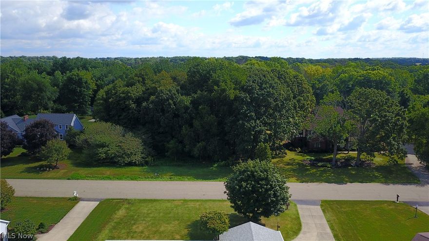 Pretty wooded 1.08 acres lot for sale in the established neighborhood of Sherwood Village. The wooded lot of mature trees is located in between two other homes, and in the very rear of the lot the Nimishillen Creek runs through the far back of this property and neighboring homes. Great possibility to build your home if you've been looking for a nice wooded lot in Plain Township. There are no utilities in place, purchaser would have to put in Septic and Well. No sewer or water available. Take a drive past and feel free to walk the property. Beautiful setting, great potential, hard to find a lot like this.