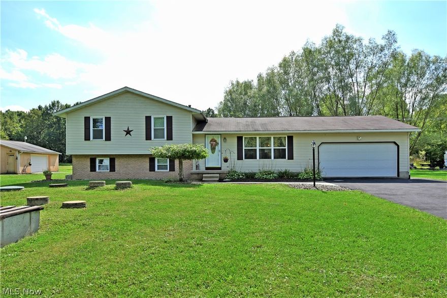 Looking for something with a little more room? Check out this gorgeous 4 level split, featuring 5 acres, 2 car attached garage AND a 32x28 detached garage; even includes a private pond and swimming pool! Enjoy both the privacy and the views that surround this well-kept Champion Township home. Inside, be welcomed in by a charming living room that shares the open floor plan with the nearby kitchen and dining areas. Hardwood style flooring runs below as it reflects the natural sunlight that cascades in from the large picture windows. Sliding glass doors at the far wall offer rear patio entry while the dining area boasts a huge reveal into the lower family room. The kitchen has been updated with a glass tile backsplash and marble look counters that pair with the natural finish cabinets. Bar seating is also available at the island. Upstairs, three colorful bedrooms invite with carpeted floors and great closet space. The master bedroom suite contains its own huge walk-in closet and full private bath with bespoke tub, stalled shower and sizeable vanity. The show stopper is the 2nd floor laundry room mid hall next to the updated full bath with great looks and tile flooring. The lower level offers a 4th bedroom and half bath before entering the massive family room with a wood burning fireplace. The lowest level provides basement storage, well room for Kinetico water system, and workshop area. This home offers many updates and is truly move-in condition!