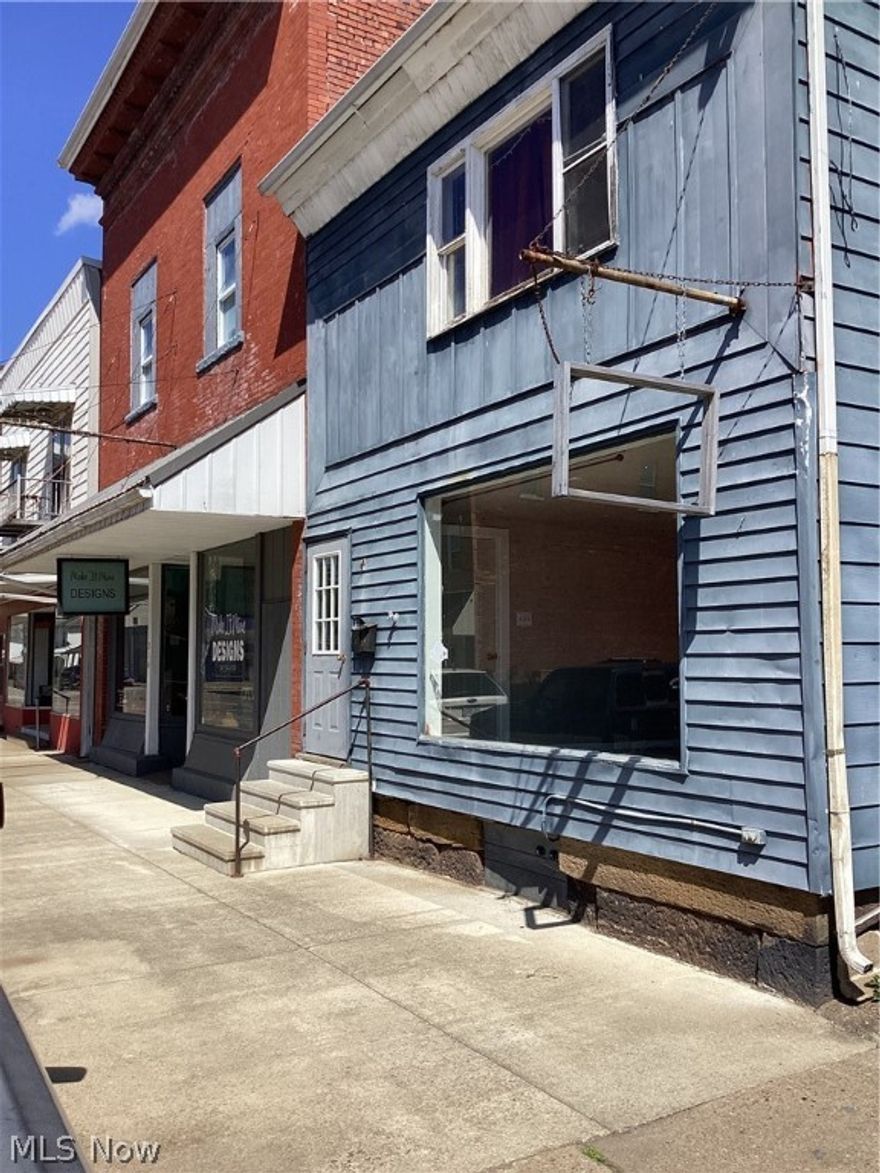 Check out this established business front. Property features, two business storefronts, four rented apartments, offstreet parking for apartments. Apartments are all electric with baseboard heat, owner is currently paying water and sewer. There are additional apartments that need updated for potential rent in the future. Market rent for one bedroom units in Tuscarawas county is $650. Owner had storefront rented out for $450. Baseboard heaters were added in 2015, new flooring and 2015 and painted in 2015 for all back three apartments. New roof on storefront to the left in 2016. Owner is unsure of age of roof for other storefront.
