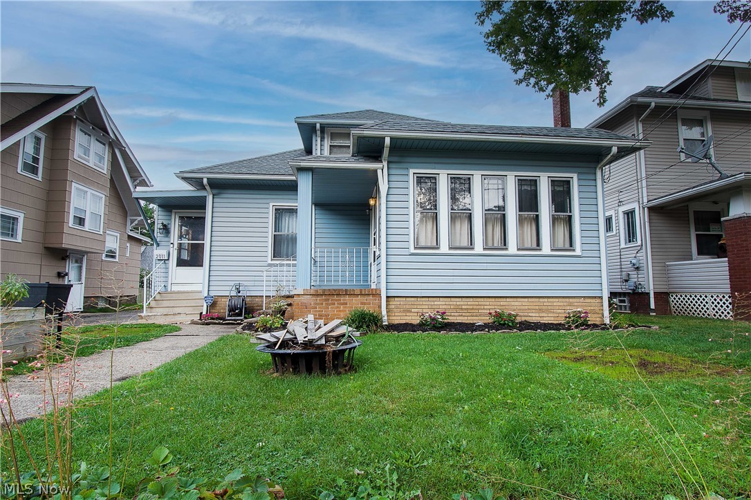 This charming home is mainly one-floor living except for a large 3rd bedroom on the upper level. It is bright and open with high ceilings on the first floor. The great room is spacious and has French doors that open to a lovely four-season room with abundant natural light. The eat-in kitchen offers a center island, plenty of cabinet space, stainless refrigerator & dishwasher, a full-size pantry with pull-out drawers, tile backsplash, and skylight. Upstairs is a unique 3rd bedroom with an exposed chimney stack and would make a great owner's bedroom, office, or kids/teenaged space. The lower-level/basement is partially finished and has an office/craft room, a laundry room with a full bath, a workshop room (11x12), and plenty of storage space. Cute mudroom inside the front door before you enter the kitchen and a shared driveway with a one-car garage. Close to historic Ridgewood and within walking distance to Malone University. Make an appointment for your private showing today!