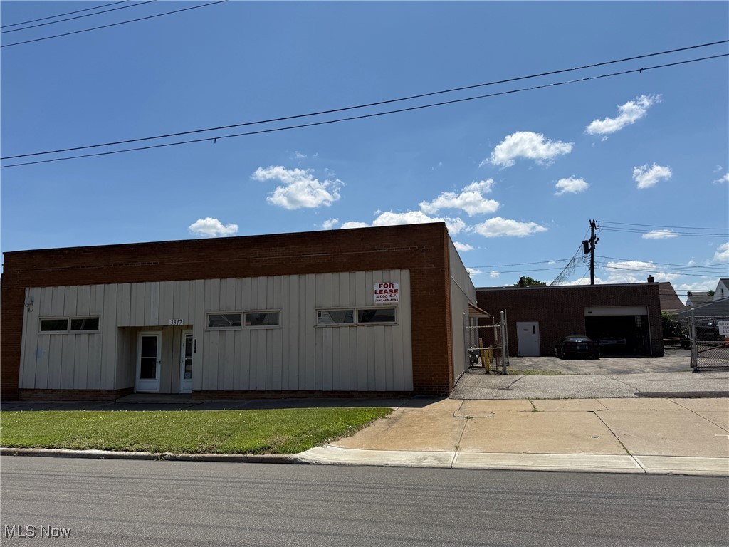 High-traffic, high-visibility commercial/retail space right on Brookpark Rd in Parma! This amazing space is currently used as storage and light auto repair, plenty of room for a lift. Includes a huge overhead door and approx 18' high ceilings. Other features: multiple office spaces, retail area, 3 rest rooms, gated parking, plus additional parking lot in front of the gated area. Owner will consider dividing the space (separate entrance, 3315 Brookpark, would not include the overhead door, see listing #5146902). Building has security system and cameras.