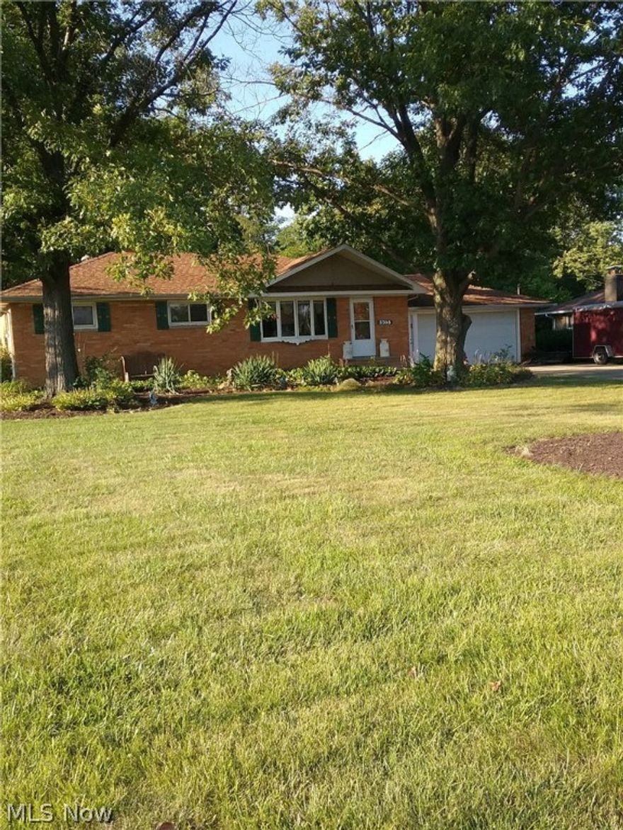 Rare find in this Brick Ranch situated in an area of fine homes. This home comes with an extra wooded lot giving you over an acre of scenic views. 30x20 Barn with concrete floor and wood burner, already set up for a shop or what ever you desire, also there is a 12x8 shed along with  a 2 car garage and extra pad for  RV. The home has a 23' country kitchen, (formal  dining area if desired) oak cabinets, breakfast bar, raised ceiling with beams, hardwood floors , updated baths. 3 season sun room leads to a deck. Finished basement. New roof , furnace & air in 2013. Mature trees. A MUST SEE! Price right,  We welcome you to visit and compare.