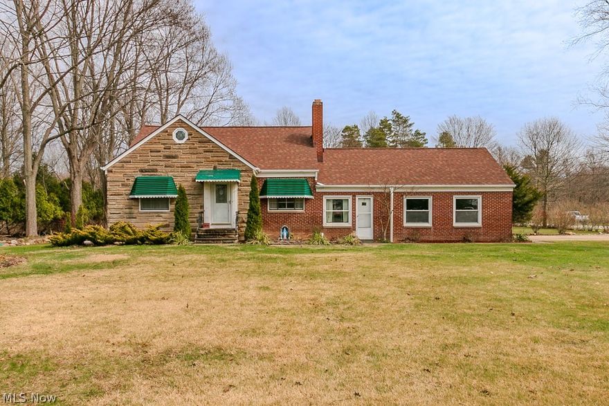 Charming brick bungalow set on a peaceful 2-acre lot in desirable Willoughby Hills! Owned by the same family since the day it was built, this well-maintained home offers a rare opportunity to enjoy beautiful land, a quiet setting, and a truly special location. A spacious breezeway connects the 2-car attached garage to the kitchen, adding convenience and extra functional space. Inside, you’ll find gleaming hardwood floors, a cozy fireplace in the living room, and a bright eat-in kitchen that comes fully applianced and opens to a covered porch overlooking the property. The main floor includes 2 nicely sized bedrooms with hardwood floors and a full bath with charming ceramic tile. Upstairs features an oversized third bedroom with built-ins and additional attic storage. The lower level offers a partially finished space with a bar, perfect for entertaining. The setting is the true standout here, with plenty of room for gardening, enjoying nature, or simply taking in the privacy and beauty of the acreage. Ideally located within walking distance of North Chagrin Reservation and Hach-Otis State Nature Preserve, with Squire’s Castle less than a mile away, shopping nearby, and downtown Willoughby just minutes away. Septic replaced in 2013 and roof new in 2020.