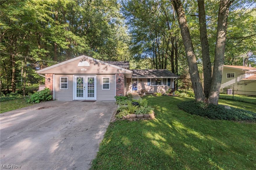 Set on over a half an acre of serene property, there is plenty of room for everyone in this split level home.   A large, open living room that flows easily into the dining room greets you as you step inside the home.  The kitchen overlooks the expansive deck (with large, functioning hot tub) and beautiful wooded backyard.  Upstairs you'll find three bedrooms with double closets and a full bath, while a fourth bedroom and half bath can be found on the lower level.  The laundry room is also on the lower level.  The media room is a huge surprise and comes with a built in bar, making it a great entertaining space.  Plenty of room for lawn equipment in the backyard storage shed.  Furnace 2015, A/C 2020.  Close to shopping, highways and schools - there is a great place to call home!