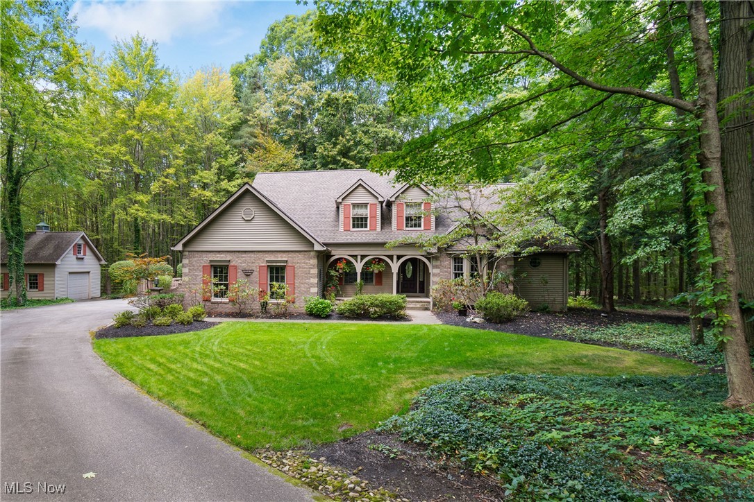 Open House: Sunday Sept 14th from 1PM to 3PM. Welcome to 11510 Robin Wood Ln, a stunning Cape Cod retreat nestled on 3.5 private acres in the award-winning Kenston School District. This thoughtfully designed 4-bedroom, 2.5-bath home offers 2,665 sq. ft. above grade plus an additional 1,100 sq. ft. of finished lower-level living space, blending architectural character with modern updates.
Step inside to a two-story foyer that opens to a soaring cathedral-ceiling living room with a wall of windows showcasing breathtaking wooded views. A double-sided glass fireplace connects the living room and chef’s kitchen, where you’ll find granite countertops, stainless steel appliances, and a vaulted eat-in area that flows seamlessly to a cedar-lined screened porch and deck—the perfect place to relax among the trees and wildlife.
The first-floor owner’s suite is a private sanctuary, complete with a walk-in closet, spa-like bath, backyard views, and a spiral staircase leading to a lofted bonus space ideal for an office, sitting room, or retreat. Three additional bedrooms and a skylit loft upstairs provide comfort and flexibility for family or guests.
The lower level is built for entertaining with a spacious recreation area and bar. Solid wood doors, custom trim, and architectural details give every room a sense of warmth and distinction.
Outside, enjoy a true nature’s paradise with mature landscaping, perennials, and even a front waterfall feature. A 16x20 heated pole barn with loft storage, 3-car garage, geothermal heating and cooling, 32kW whole-house generator, and recent updates including a new water treatment system (2024) and hot water tank (2025) ensure convenience and efficiency.
Located just minutes from downtown Chagrin Falls and with easy access to the Cleveland metro area, this home offers a rare combination of privacy, natural beauty, and modern comfort.
Discover the lifestyle you’ve been waiting for—schedule your showing today.