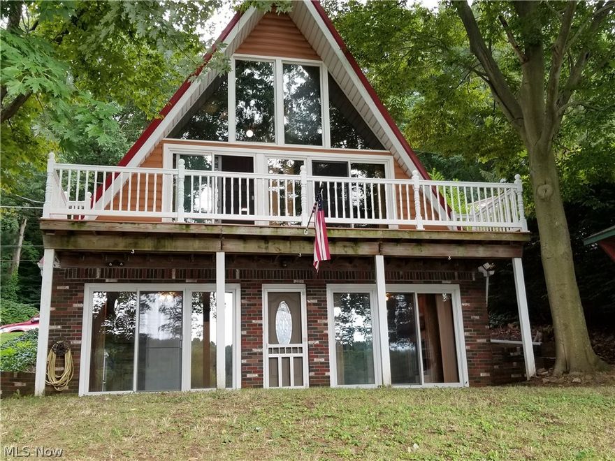 Lakefront - Adorable A-Frame - Dock - Lakefront!  Living Room with 2 new sliding doors to full length deck with gorgeous views of the lake, spiral stairs to loft.  Kitchen / Dining area with Nature Stone floor, 2 ceiling fans, beautiful fireplace (propane) with oak mantel & 2 sliding doors + entrance door to cement patio and backyard (lake).  2 BD's both with ceramic tile floor, full bath (shower stall), Kitchen with ample cabinets + appliances.  Shed, deck and DOCK!