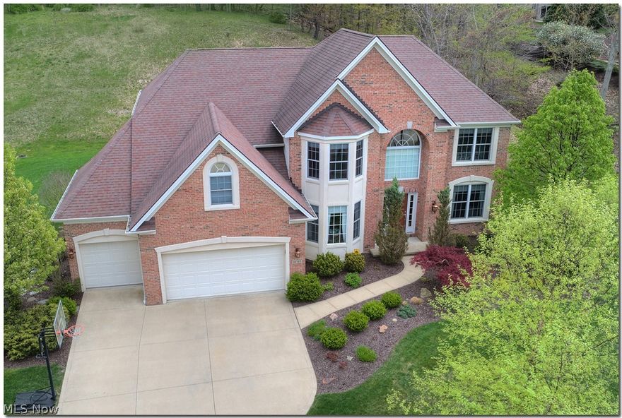 Exceptional, 4 bedroom 3 1/2 bath custom-built beauty!  This impeccable home offers a welcoming 2-story foyer,  formal dining room with elegant pillars,  living room, and a 2-story Great room with a gas fireplace, and a wall of windows with panoramic views of the private yard. Every detail has been perfected in this home!  From the elegant wainscoting, to chair railing & crown molding,  this home has tremendous appeal!  The gourmet kitchen is equipped with a breakfast bar, Cherry cabinets, hand carved wood flooring, desk area, walk-in pantry, granite counter tops, and stainless steel appliances.  Located off the kitchen is a fabulous morning/sun room, perfect for peaceful & relaxing moments.  Also included on the 1st level is a guest bath, a den with French doors, and a laundry room off the kitchen.  The 2nd floor offers a sensational master suite complete with a spacious walk-in closet, vaulted ceiling, a glamour bath with a soaking tub, separate shower, & slate flooring.  There are 3