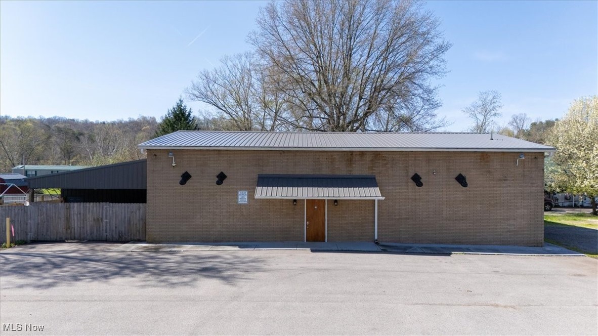 Commercial opportunity for this property that was formerly the bar called The Rendezvous Lounge. The building features block construction with steel truss/joists - New Metal roof in 2022 - Two New HVAC units in 2022 - Men's and Women's Restrooms -
Updated lighting - Updated Electrical - Newer Ceiling Fans - Full Bar - Camera Security system with motion sensors - Total of 6 Man door Exits - Multiple Buzzer switches to unlock front entrance door - Large asphalt parking lot - Multiple use property. Would make a Great man cave garage with the addition of an overhead garage door. For Sale OR Lease. Lease price is TBD.