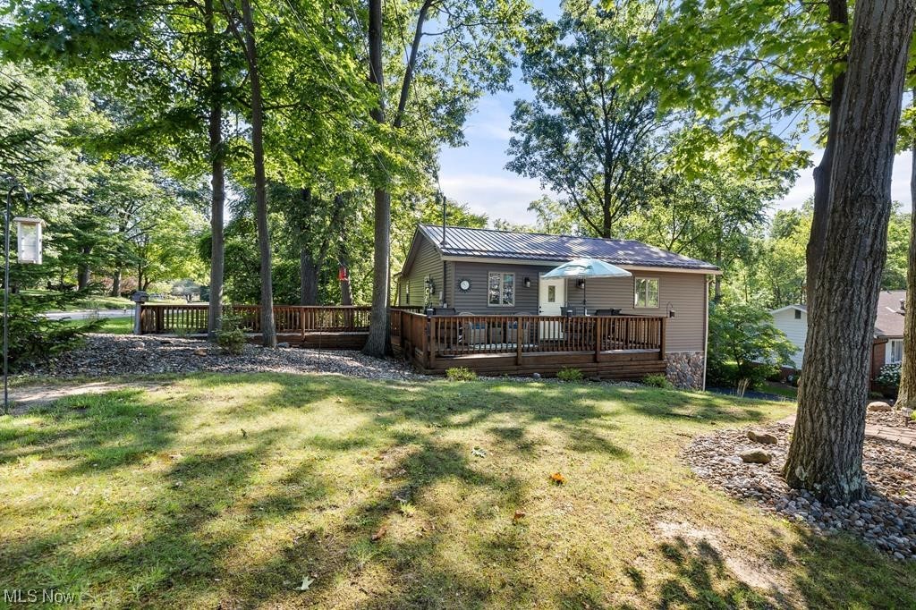 Just In Time For Your Next Home! This ranch home features 3 bedrooms & 3 full baths. Master bedroom and Living room has natural wood vaulted shiplap ceiling with access to the 7'x10' 3 season room, overlooking the properties wooded lot. Open floor plan makes the living room, dining room, and kitchen great for entertaining family and guests with an updated stone wood-burning fireplace. Finished basement has the 3rd bedroom with access to the 10'x10' 3 season room that leads to the wrap around deck. Updates include a new metal roof and skylight in 2019; master bath in 2020; furnace, A/C and water heater in 2021, linked smoke detectors in 2021; Remodeled lower level bath, laundry room, flooring and Garage door in 2023!
