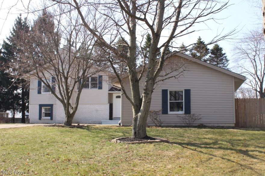 As you enter through the front door you are welcomed by a spacious and bright Living Room. Attached to the Living Room is an updated eat-in kitchen with newer stainless steel appliances, ceramic floors, pantry, also a bay window. The Dining Room has a double door access to the large deck and the fenced in back yard. Located on the first level is a wood burning fireplace and a lovely beamed ceiling. In addition, is a half bath, a bedroom, laundry hookups, and a door to access the backyard. Upstairs offers a large full bath along with 3 spacious bedrooms. The master bedroom has double closets and a good sized master bathroom with ceramic floors and a newer shower. The deep 2 car garage has plenty of room for your vehicles and plenty of storage. Outside features include some of the following: cement driveway, gate to access the backyard, and freshly mulched beds.