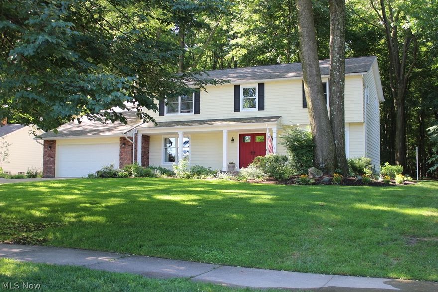 Nestled on a quiet street and on a very wooded and private lot sits a home that has been well cared for and loved. The home backs up to woods and allows the owner privacy and the luxury of sitting on the deck and enjoying the peace and quiet. Inside this lovely home you will find hardwood floors in the Dining Room and slate floors in the Kitchen. The Kitchen was remodeled in 2010 with beautiful cherry cabinets, granite counters, a center work island with built-in shelving on the side, all GE Profile appliances, desk for planning and beautiful views of the backyard. The eating area in the Kitchen is spacious and allows for nice and open entertaining. There is a large Living Room that spans the length of the home and has a magnificent front windows with a window seat that looks out into the front yard with big enough trees that provide just the right amount of privacy. The large Family room has beamed ceilings, wood burning fireplace, sliding doors to the deck and a wet bar complete with