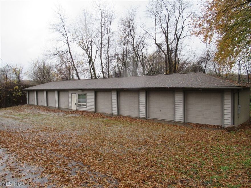 Great commercial location with 8 separate garage units and a living area/office space between units.  Can be used for many uses including small business storage, individual unit rentals, etc.  Three additional properties behind main buildings again have unlimited potential, all utilities available including public water and public sewers.