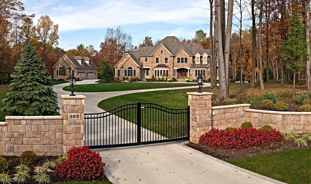 More than a house.......a gated estate on 7 acres near The Cuyahoga Valley National Forrest, with access to biking & hiking trails just steps from your door. This magnificent private estate offers the finest of finishes. Custom millwork, beautiful cabinets, flooring & lighting throughout. Each of the 3 private large suite bedrooms contain a walk in closet & full bath. A second floor laundry room, 1\2 bath & bonus room rounds out the 2nd floor. This home is an entertainer's dream with a rustic modern decorated multi walk-out basement including an exercise room, living room, bar area, video game room, Alder wood paneled office, pool table area, & 10 seat tiered theater, two full baths; one of which adjoins a locker room for pool days. Equally impressive is the outdoor area; your very own resort has a pool with mechanical closure, slide & diving board surrounded by a large stamped concrete patio. Large cabana with stone wood burning fireplace, ceiling fan & outdoor TV which is adjacent to the granite topped kitchen area with built in natural gas supplied grill, cooler & refrigerator. Tennis court is regulation size! Security cameras, gated driveway & fenced yard offer high-tech security! Hudson School District