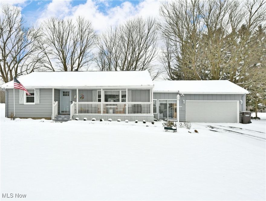 Heat up these cold winter days with the warm vibes from this beautifully updated Bazetta home! Offering a desirable two-bedroom ranch layout with provisions for a third lower bedroom, this residence has everything you’ve been looking for. Standing out, the endearing, gray exterior is quick to draw you near, taking in a brick walkway and picket lined, covered front patio for spring days to come. A must-see finished breezeway connects the attached two car garage with a perfect lounge and casual entrance. Through the front door, a captivating living room showcases its large picture window, carpeted floors and its rustic accent wall as bespoke lighting presides overhead. The main hallway separates the nearby kitchen where lovely, eat-in dining veils the hidden first floor laundry found behind bi-fold doors. Sunshine cascades across the hardwood styled flooring, lighting the faux-stone countertops and glass tiled backsplash. Recessed overhead lighting joins the stainless appliances to brighten the room. Down the hall, a pair of spacious first floor bedrooms branch away with plush carpets and ample footprints. They are joined by a charming full bath and its updated vanity. Downstairs, provisions for the third bedroom outreach into an excellent family room with a built-in entertainment center. Nearby, a second full bath brings an elaborately tiled shower. Opposite, shop and storage space complete the floor.  Many, many updates include:  Covered front porch & brick sidewalk; garage door & opener; Ring security system; landscaping (including filling ditch, removing overgrown bushes, grading and planting bushes); expanded kitchen (w/ new plumbing, appliances, gas line to range & breezeway; storm doors & metal exterior doors; windows (except the picture window); light fixtures; vanity, mirror & fixtures in primary bath; radon mitigation system;  hot water tank; self-contained whole house water filter & RO system to kitchen sink & fridge;  blinds & flooring.