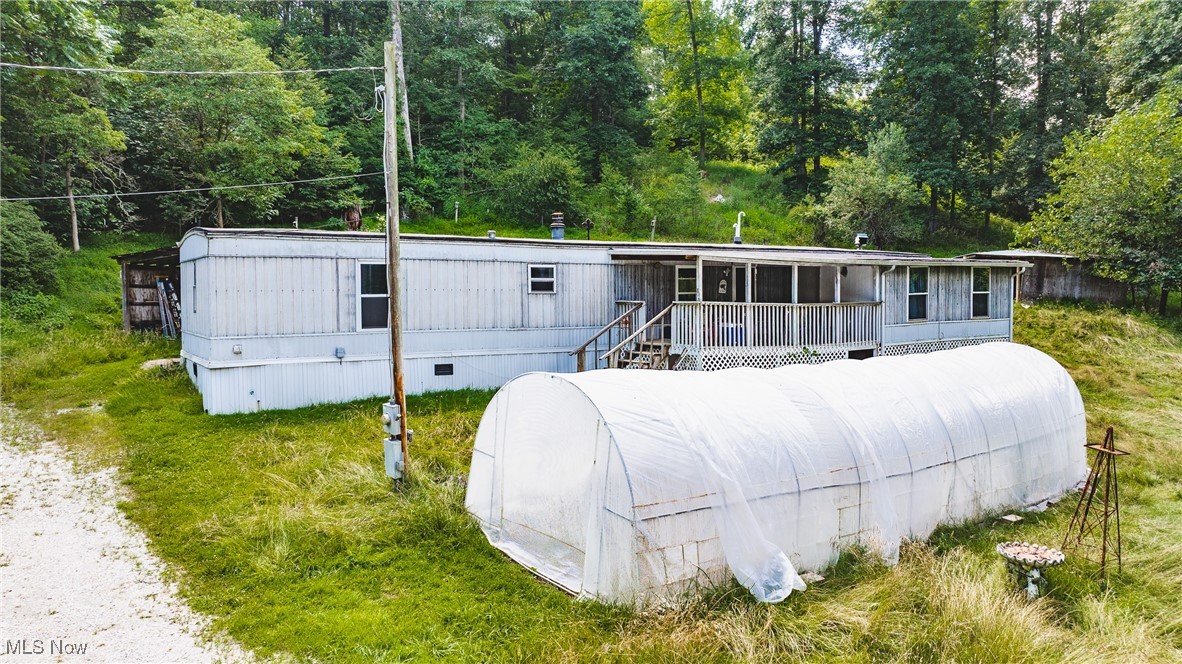 Peaceful Country Living on 11+ Acres – All Rights Convey! A rare find – all oil, gas, mineral, and timber rights convey with the sale, adding long-term value to your investment. Your Private Retreat Awaits! Welcome to your next great opportunity! Tucked away in a serene and wooded setting, this spacious 4-bedroom, 2-bath manufactured home sits on 11.06 acres of beautifully treed land, offering the perfect blend of privacy, potential, and investment. This home features a wood-burning fireplace insert, perfect for warm, relaxing nights. With a little TLC, you can restore this home to its full potential and make it your dream country getaway. Inside, you'll find 4 generously sized bedrooms and 2 full baths, with a spacious layout ready for your personal touch. Propane gas provides efficient heating, and there's ample potential for off-grid or sustainable living. The acreage offers room for gardening, trails, hunting, or even building an additional structure. Whether you're looking for a homestead, a hunting retreat, or a peaceful weekend escape, this property has the space and flexibility to make it happen. Set back from the road, the home offers peace and seclusion while still being conveniently located to nearby towns and amenities. Don't miss this chance to own a piece of nature with endless upside potential. Schedule your private tour today and see the possibilities for yourself!