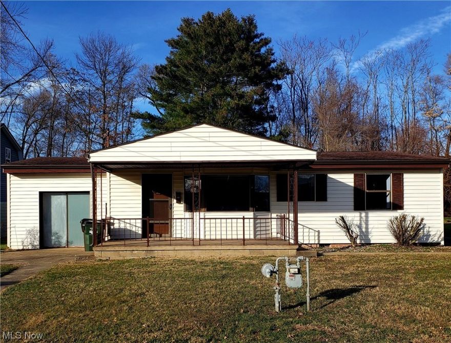 Ranch home features three bedrooms, one bathroom and oversized two-car detached garage.  Step inside the living room with beautifully refinished hardwood floors, spacious bay window and a feature wall with electric fireplace insert.  Cozy up in the eat-in kitchen with includes appliances, and a step down to the bonus room and laundry area.  Outside, there is a screened-in back porch, which opens to a patio and flat back yard.  Updates include new 100-amp electric service, new furnace and air conditioning and fresh paint throughout.  There are hardwood floors under the bedroom carpeting.  Home is situated on a conveniently located dead-end street.  Imagine the possibilities.
