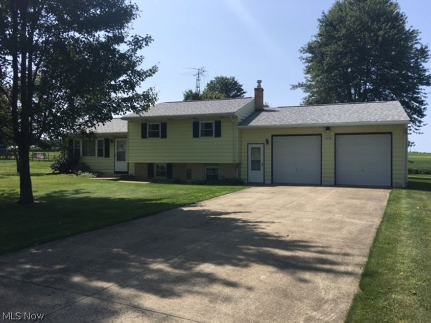 Enjoy country living on almost a half acre, while being just minutes from Wooster's north end.  Newer roof shingles, windows, septic aeration system and free-standing gas fireplace in lower level family room.  Large over-sized 2-car attached garage with 8 X 8 doors.  Peaceful and beautiful back yard includes a nice 12 X 16 shed.  Bring your personal touches and make this house your home!