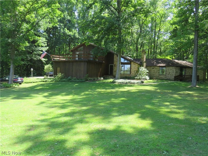 Back in the woods, this custom-built, brick and cedar 4 bedroom, 3.5 bath home offers 3 private decks, a huge balcony, screened-in gazebo, partly finished basement with 2 furnaces, 2 air conditioners, 2 stoves, 2 sets of washers and dryers, one gas and one electric stove, 2 refrigerators.  Like your own private park setting.  Great house flow with a half bath off the garage and laundry near the basement entrance.  Plenty of table seating areas with a wood fireplace in the lower kitchen area and the living room.  The office/den room leads through a door to the extra living suite that gives you a complete 1 bedroom apartment set up with its own front entrance and own rear deck.  There is even a loft above the bedrooms for when the young ones come to visit or for extra storage. Septic installed in 2009 and the rubber garage roof was new in 2017 that is under the Trex upper deck that is off of two of the bedrooms.  First drive to the east of Fenstermaker Road.