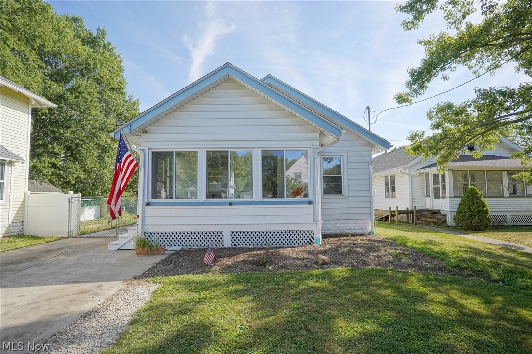Check out this cozy home located in the heart of Ravenna. You are greeted by the sunroom that leads to the main living space with fresh brand new carpet. There is a formal dining room space off the living room which leads into an eat in kitchen with stainless steel appliances. Two bedrooms and full bathroom are located on the main floor. Downstairs, feature naturestone flooring with plenty of room for storage. Laundry room and bonus room which at one point was used as a music room. Large backyard with plenty of space. You will not want to miss this home. Features: new carpet in living and dining room, fresh paint in main living space, AC/Furnace new March 2020, Water Tank 2016, Fridge and Range in 2018.