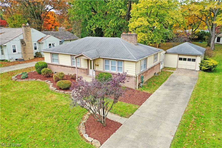 Your search ends today! This charming three-bedroom Boardman ranch puts you just minutes away from Mill Creek Park and its scenic views. Well-manicured landscaping quickly catches your eye as a concrete driveway adds to curb appeal as it leads up to a one and a half car garage. A curving sideway runs past the red mulch beds to the covered front patio as you step inside. Here, a welcoming living room is awash in the natural light courtesy of a multiple tall windows that join the decorative glass entry door. Hardwood styled flooring runs below as a brick encased fireplace makes for a center showcase. An arched entry takes you into the robust kitchen, offering plenty of room for casual dining between its wrapping countertops. Peer into the nearby sunroom, a perfect place for warm weather relaxation. Down the main hall, a tastefully updated full bath joins the trio of carpeted bedrooms, accented in clean, white trim work. Below, a full basement completes the package with laundry, storage,