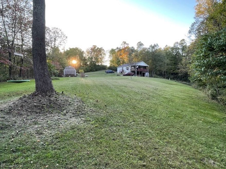 Charming & Cozy! This adorable, remodeled, raised ranch is situated on almost 10 acres with a creek along the backside of the property. Thoughtfully designed with views from every window, a large kitchen with granite countertops open to both the living room and dining room, two bedrooms, two full bathrooms, 1st floor laundry and flex space, currently used as a playroom, could make an adorable office or lounge space. Outside you'll find a spacious covered balcony with porch swing, also serving as a carport, an amish built shed, a 50 yard gun range with two lanes, trails and a creek. The amish built shed is 12X20, with two 8' lofts and is wired for electric. Updates: Water system installed, added reverse osmosis, replaced well pump, septic repaired & pumped.