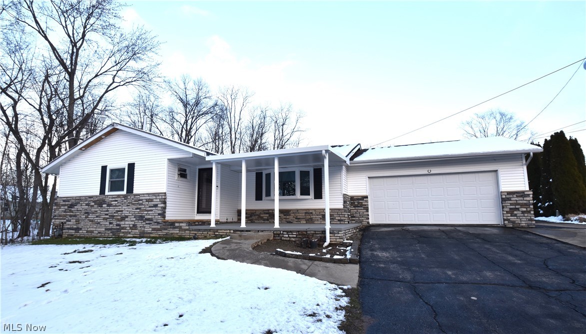 Welcome to your own, private, slice of country in northern Springfield Township. When you drive up the wide, double driveway you'll notice the new vinyl siding paired beautifully with provia stonework and soffit lighting making this home have maximum curb appeal. This wonderful property includes a two car attached garage, a two car, heated, detached garage with workspace, a two story 12x7 building, a 10x20 tent, and a 12x12 shed. All outbuildings are equipped with electric to get those outside jobs done more efficiently! Inviting deck and 20x10 patio for your outdoor entertaining. Upon entering this updated ranch, you will find the large living room, perfect for hosting large family gatherings or having a quiet movie night. Eat in kitchen with beautiful granite countertops, brand name appliances, and new LVT vinyl flooring. There are also three spacious bedrooms on the main floor as well as a full bath. The master bedroom has an attached 2nd full bath and plenty of closet space. Downst