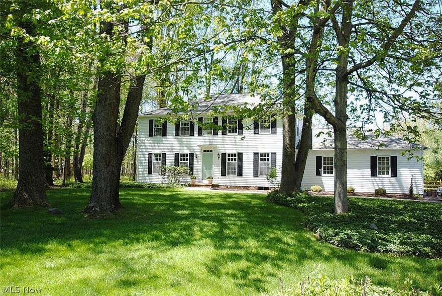 Beautiful colonial in great condition w/ younger mechanicals & roof. The newer kitchen has granite counters, cherry cabinets & a sliding door to the deck & an incredible view  that overlooks the Chagrin River. Enjoy 2.3 acres w/ the back yard being limited with a deck, but which has a large side & front yard, sitting on a quiet cul-de-sac. Steps could be installed down the hill for easy access to the river since the lot extends all the way down to  it.  It is not the home for anyone looking for a large backyard. Beautiful hardwood floors run throughout the entire first floor w/ slate in the foyer. The family room has a great rustic fireplace & large doorway to the living room allowing it to be part of the family room for a large crowd. The Master Bath shower is "handicap friendly" but is also the “newer style” that is more open. The laundry room is off the back hallway & doubles as a mudroom.   This is a  one owner home with many great improvements & some fresh painting . Priced for th