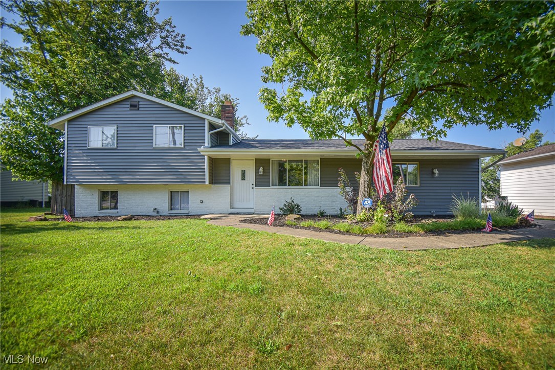 Welcome to this charming 3-bedroom, 1.5-bath split-level home, featuring a spacious layout and beautiful outdoor spaces. Step inside to a bright living room with a vaulted ceiling that flows seamlessly into a large family room—perfect for entertaining or relaxing. The kitchen is centrally located and offers an eat-in area along with sliding glass doors that open to a massive back deck, ideal for outdoor dining or gatherings. A second exit off the kitchen provides additional access to the backyard and the detached 2.5-car garage. Upstairs, you’ll find three generously sized bedrooms with gleaming hardwood floors and a full bath. The lower level adds even more functional space with a rec room, half bath, and a dedicated laundry area. Enjoy the private backyard, complete with lovely landscaping and room to unwind. Major updates include a new roof, siding, and gutters (2025), offering peace of mind for years to come. Don't miss your chance to own this well-maintained home with great indoor and outdoor living space!
