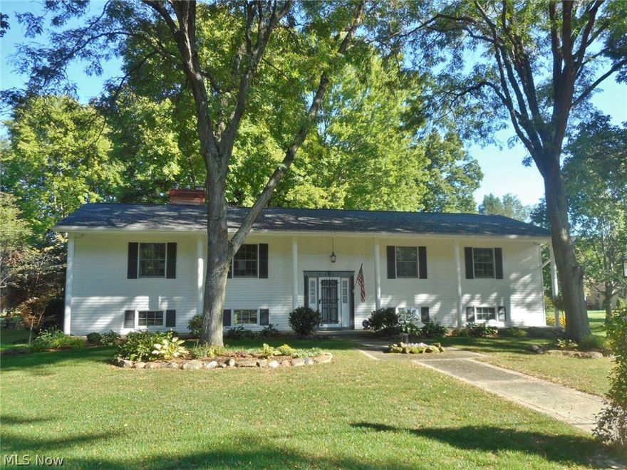 Great bi-level with gorgeous treed backyard - views into Blu Bird Lake. Remodeled kitchen with newer maple cabinets, granite countertops. Year round sun room off the kitchen - large dining - living room with fireplace and lower level family room with gas stove.  Baths have been updated also - roof new in 2016 - 18x22 outbuilding.